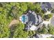 Grand estate showcasing impeccable architecture, mature trees, a private pool area, and a circular driveway at 854 Club Moss Ct, Marietta, GA 30068
