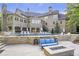 Large backyard featuring a pool, fire pit, and multiple outdoor living spaces at 854 Club Moss Ct, Marietta, GA 30068