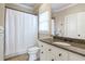 Cozy bathroom featuring single vanity with granite counters and shower-tub combo with shower curtain at 854 Club Moss Ct, Marietta, GA 30068