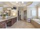 A well-lit bathroom boasts a large vanity, soaking tub, walk-in shower, and elegant finishes at 854 Club Moss Ct, Marietta, GA 30068