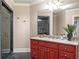 Bright bathroom featuring a glass shower and a red vanity at 854 Club Moss Ct, Marietta, GA 30068