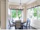Charming dining area with a chandelier and large windows offering natural light and green views at 854 Club Moss Ct, Marietta, GA 30068