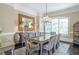 Elegant dining room featuring a glass table, chandelier, and large decorative mirror and birdcage at 854 Club Moss Ct, Marietta, GA 30068