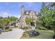 Beautiful stone and brick home with lush landscaping and a curved driveway at 854 Club Moss Ct, Marietta, GA 30068