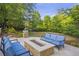Outdoor fire pit area with comfortable seating, surrounded by lush landscaping at 854 Club Moss Ct, Marietta, GA 30068