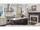 Gourmet kitchen features a stainless steel range hood, island, granite countertops, and fireplace at 854 Club Moss Ct, Marietta, GA 30068