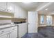 Bright laundry room with custom cabinets, a large sink, and direct access to the outside at 854 Club Moss Ct, Marietta, GA 30068
