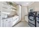 Well-appointed laundry room with modern washer/dryer, granite countertops, and ample storage at 854 Club Moss Ct, Marietta, GA 30068
