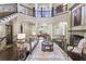 Spacious living room with high ceilings, fireplace, grand staircase, and elegant furnishings at 854 Club Moss Ct, Marietta, GA 30068