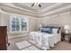 Bright main bedroom boasts a tray ceiling, large windows, and neutral tones at 854 Club Moss Ct, Marietta, GA 30068