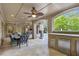 Covered patio with dining area and outdoor kitchen, perfect for entertaining guests at 854 Club Moss Ct, Marietta, GA 30068