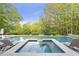 Backyard swimming pool, with hot tub, featuring lounge chairs, and lush green landscaping at 854 Club Moss Ct, Marietta, GA 30068