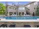 A luxury home's outdoor area featuring a large pool, covered patio and outdoor seating at 854 Club Moss Ct, Marietta, GA 30068