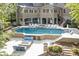 An aerial view of a backyard featuring a large pool, patio area, and lush landscaping at 854 Club Moss Ct, Marietta, GA 30068