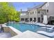 A luxury home's outdoor area featuring a large pool, covered patio and outdoor seating at 854 Club Moss Ct, Marietta, GA 30068