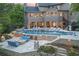Luxury home with a stunning backyard featuring a large pool, spa, and outdoor seating area with fire pits at 854 Club Moss Ct, Marietta, GA 30068