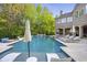 Backyard pool, with waterfall feature, surrounded by lounge chairs and lush landscaping at 854 Club Moss Ct, Marietta, GA 30068