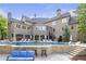 A luxury home's outdoor area featuring a large pool, covered patio and outdoor seating at 854 Club Moss Ct, Marietta, GA 30068