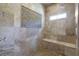 Walk-in shower featuring pebble floor and stone tile surround with built-in shower bench at 854 Club Moss Ct, Marietta, GA 30068
