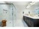 Spacious bathroom featuring marble floors, a glass shower, dual vanity, and modern fixtures at 920 Wemberley Ln, Marietta, GA 30064