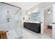 Open bathroom with marble floors, glass shower, dual vanity, and modern fixtures at 920 Wemberley Ln, Marietta, GA 30064