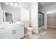 Modern bathroom with a sleek vanity, glass-enclosed shower, and access to a walk-in closet at 920 Wemberley Ln, Marietta, GA 30064