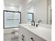 Bright bathroom showcasing a white vanity, black hardware, and a glass-enclosed shower at 920 Wemberley Ln, Marietta, GA 30064