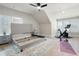 Spacious bedroom with a ceiling fan, shuttered windows, and ample space for gym equipment at 920 Wemberley Ln, Marietta, GA 30064