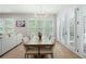 Elegant dining room with natural light, a modern chandelier, white shutters and views to the outdoor living at 920 Wemberley Ln, Marietta, GA 30064