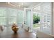 Elegant dining room with natural light, white shutters, with an open door to an outdoor living space at 920 Wemberley Ln, Marietta, GA 30064