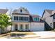Charming two-story home featuring a white facade, black shutters, and a well-manicured lawn at 920 Wemberley Ln, Marietta, GA 30064