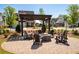 Outdoor fire pit with pergola and seating, perfect for entertaining in a cozy neighborhood setting at 920 Wemberley Ln, Marietta, GA 30064