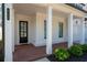 Inviting front porch with classic columns, brick flooring, and manicured landscaping at 920 Wemberley Ln, Marietta, GA 30064