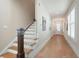 Hallway and staircase with wood floors and a front door at the end of the hallway at 920 Wemberley Ln, Marietta, GA 30064