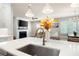 Kitchen featuring stainless steel sink, white countertop, view to the fireplace, and dining area with modern chandelier at 920 Wemberley Ln, Marietta, GA 30064