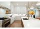 Bright kitchen featuring white cabinetry, quartz countertops, stainless steel appliances and an island at 920 Wemberley Ln, Marietta, GA 30064