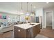 Open kitchen featuring a kitchen island, stainless steel appliances and natural light to the living and dining area at 920 Wemberley Ln, Marietta, GA 30064