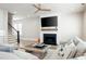 Bright living room featuring a modern fireplace, ceiling fan, and staircase in an inviting, open-concept layout at 920 Wemberley Ln, Marietta, GA 30064