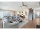 Open-concept living space with hardwood floors, a modern ceiling fan, and abundant natural light at 920 Wemberley Ln, Marietta, GA 30064