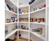 Well-organized pantry with shelves stocked with a variety of food items and clear storage containers at 920 Wemberley Ln, Marietta, GA 30064