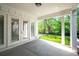 Back patio with ceiling, and view of backyard and manicured lawn at 920 Wemberley Ln, Marietta, GA 30064