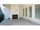 Covered patio with white columns, wood-burning fireplace, and glass doors at 920 Wemberley Ln, Marietta, GA 30064