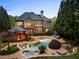 Amazing backyard featuring a sparkling pool, jacuzzi, outdoor pavilion, and lush landscaping at 1319 Glen Cedars Dr, Smyrna, GA 30126