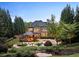 Stunning backyard featuring a spacious patio, sparkling pool with waterfall, and lush landscaping at 1319 Glen Cedars Dr, Smyrna, GA 30126