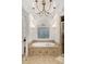 Stylish bathroom featuring a jacuzzi tub and a chandelier overhead at 1319 Glen Cedars Dr, Smyrna, GA 30126