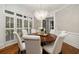 Elegant dining room with hardwood floors, white wainscoting, and a decorative chandelier at 1319 Glen Cedars Dr, Smyrna, GA 30126