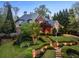Charming two-story home featuring manicured lawn, stone walkway, brick accents, and lush landscaping at 1319 Glen Cedars Dr, Smyrna, GA 30126