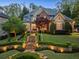 Charming two-story home featuring manicured lawn, stone walkway, brick accents, and lush landscaping at 1319 Glen Cedars Dr, Smyrna, GA 30126