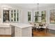 Well-lit kitchen featuring a bar, island, and dining table at 1319 Glen Cedars Dr, Smyrna, GA 30126