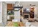 Bright living room with a stone fireplace, built-in shelving, and access to the outdoor kitchen at 1319 Glen Cedars Dr, Smyrna, GA 30126
